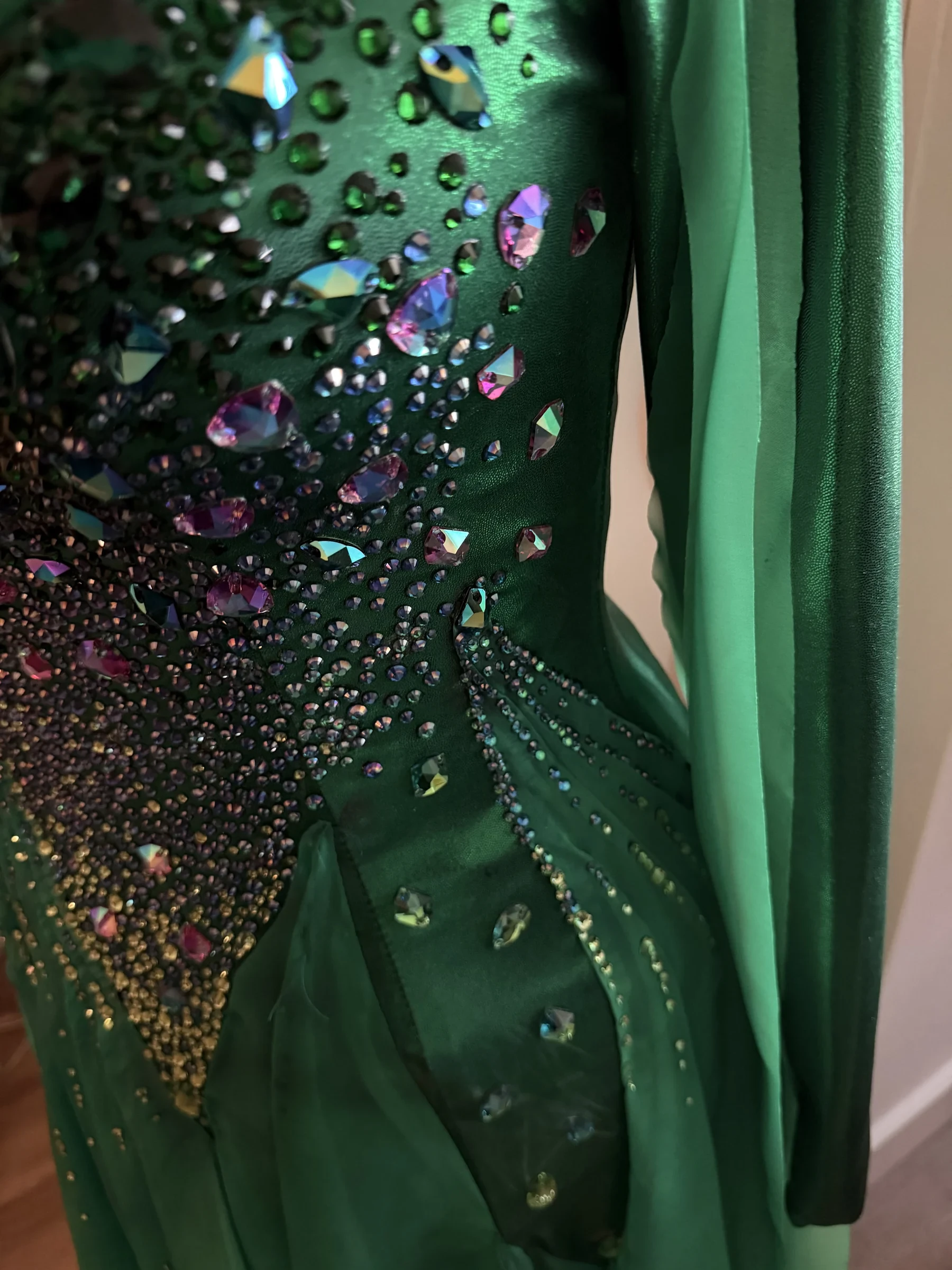 Close detail of rhinestones building across the Aurora gown